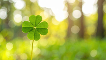 Naklejka premium Solitary green shamrock with its three vibrant leaves radiating good luck stands proud against blurred background of nature, evoking sense of tranquility and hope