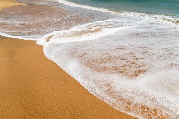 sand beach with waves close up 
