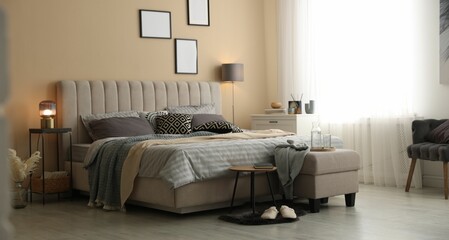 Comfortable bed with soft linens and blankets in room. Home textile