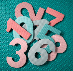 Colorful numbers resting on textured teal background