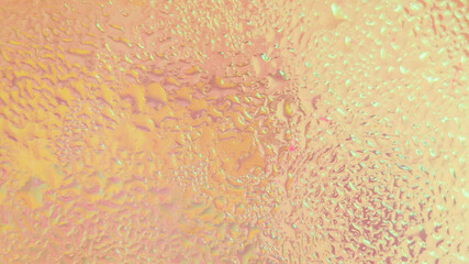 Abstract background of water drops on glass with yellow gradient light