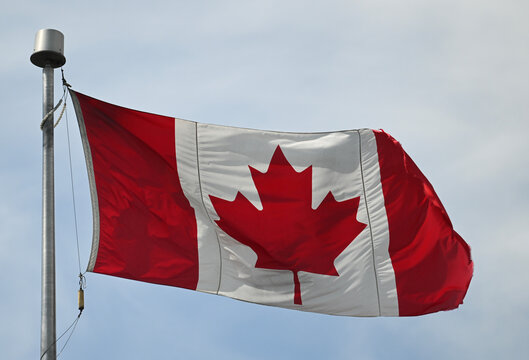 A Canadian flag flaps in the wind
