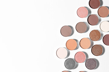 Beautiful eyeshadow refill pans on white background, flat lay. Space for text