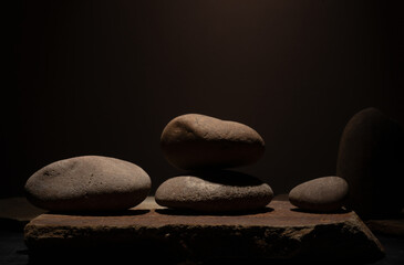 Composition with brown flat and smooth oval natural zen stones with texture for podium presentation...