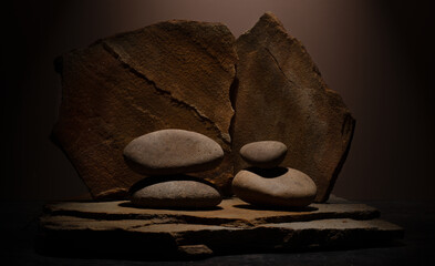 Composition with brown flat and smooth oval natural zen stones with texture for podium presentation...