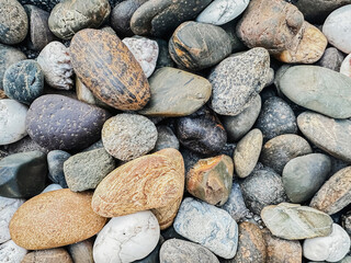 Close-up of different sized river bank rocks.