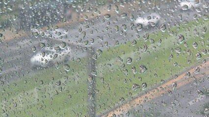 Rainy day cars outside the window and raindrops on the glass.