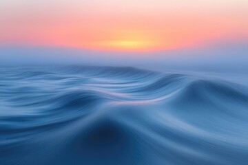 Obraz premium Calm ocean waves with a blurred effect, lit by a soft, pastel sunrise sky with gentle colors.