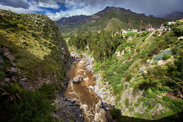 The impressive Colca Canyon unfolds in layers of dramatic cliffs and deep valleys, carved by centuries of flowing water and shifting earth. Twice as deep as the Grand Canyon