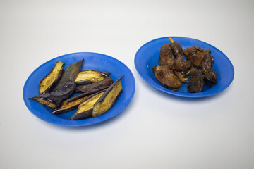 Fried eggplant and gizzards served on a blue plate.