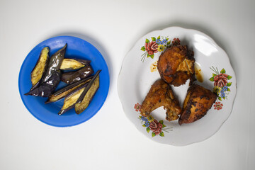 Delicious fried chicken and eggplant neatly arranged on two different plates