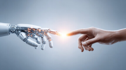 Futuristic robot hand and human hand reaching out to touch with glowing light between fingertips, symbolizing connection and technology