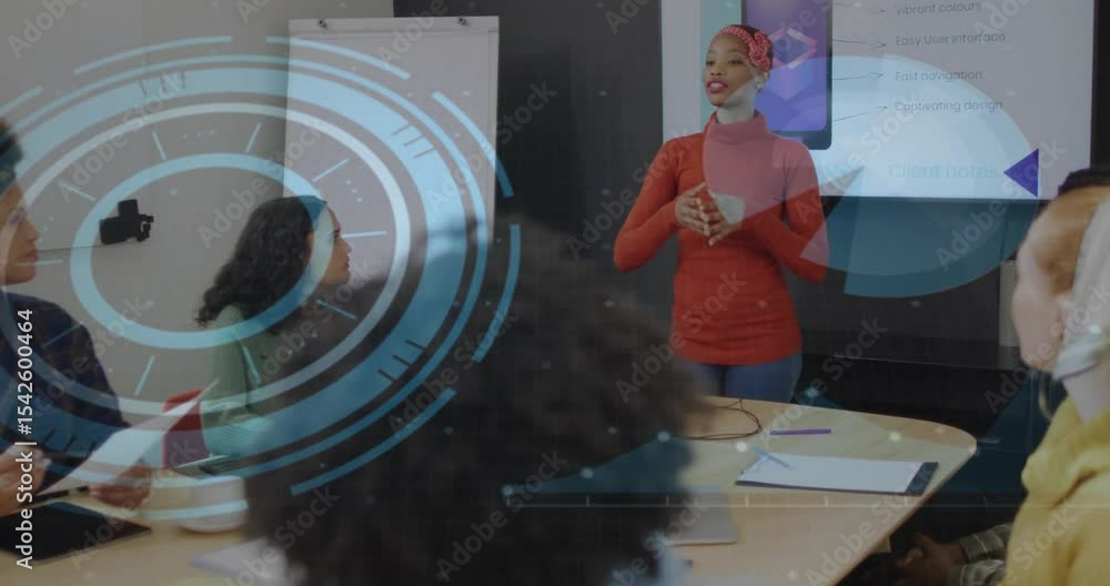 Poster Presenter speaking, gesturing in meeting while team noting and hologram rotating on display