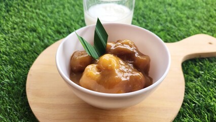 Candil porridge is made from sticky rice flour, brown sugar and coconut milk, shaped like balls or...