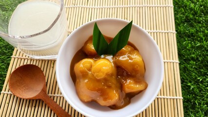Candil porridge is made from sticky rice flour, brown sugar and coconut milk, shaped like balls or...