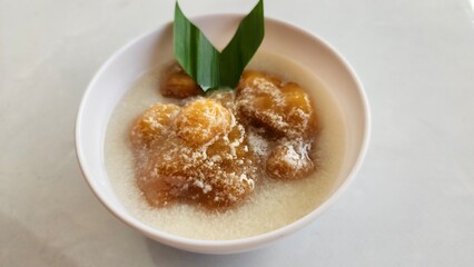 Candil porridge is made from sticky rice flour, brown sugar and coconut milk, shaped like balls or...