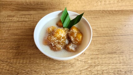 Candil porridge is made from sticky rice flour, brown sugar and coconut milk, shaped like balls or...