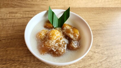 Candil porridge is made from sticky rice flour, brown sugar and coconut milk, shaped like balls or...