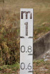 Close-up of a flood level marker indicator in a grassy environment in Australia
