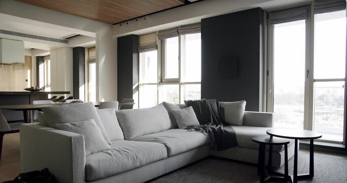 Modern contemporary Minimalist living room with confortable white sofa furniture. Luxury Modern House Interior With Corner Sofa. Fashionable furniture. Minimalist Home Interior. Luxury Elegant Room