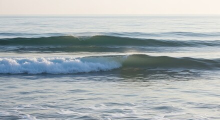 Fototapeta premium Calm Ocean Waves Rolling to the Shore on a Summer Day