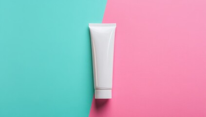 White tube of cream or lotion on teal and pink background
