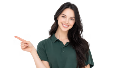 A cheerful young woman in a green polo shirt smiles while pointing to the right. set against a plain white background. ideal for promotional materials or social media content