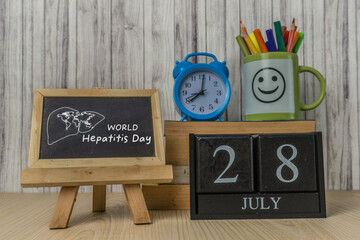 World Hepatitis Day 28th July Concept With Alarm Clock and Chalkboard