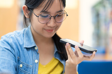 Young Woman Using Voice Assistant on Smartphone