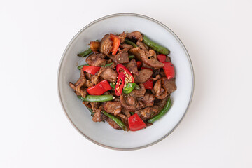 Stir-fried beef with sweet pepper and green peas on white background