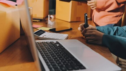 Entrepreneur, small business, SME, freelance woman working from home with lots of boxes on the side. Use smartphones and laptops for commercial monitoring. online marketing packaging box online sale