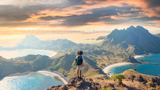 Hiker on hill with panoramic mountain and ocean view at Padar Island, Komodo National Park, Indonesia. Ideal for summer vacation, adventure, and travel inspiration.