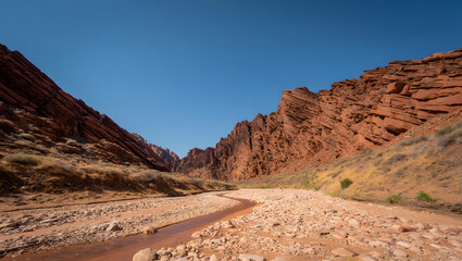 Fototapeta premium Desert roads wind through red rock landscapes, revealing scenic mountain valleys and majestic sandstone canyons in the American Southwest