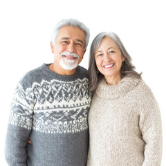 A joyful elderly couple poses together in cozy sweaters. smiling warmly at the camera against a clean white background. conveying love and companionship in a serene setting