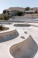 Fototapeta premium Aerial view of a vibrant skatepark surrounded by fortress walls ideal for skateboarding enthusiasts