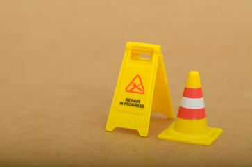 Yellow Repair in Progress Sign: Symbol of Caution and Incomplete Work in a Conceptual Visual Format