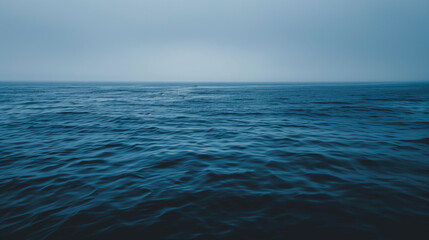 Obraz premium Blue sky over calm sea. Blue sea and sunny sky on horizon over calm water