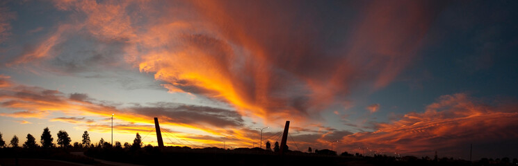 Panoramic view of a dramatic and colorful stormy sunset with bridge stanchions in New South Wales,  Australia_20101217_panorama4