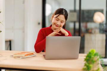 Business Asian woman using calculator and writing make note with calculate doing math finance on an...