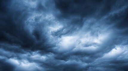 Obraz premium Dramatic storm clouds in deep blue, a sweeping skyscape with dynamic light, nature's raw power on display