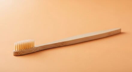 Wooden Toothbrush on Peach Background