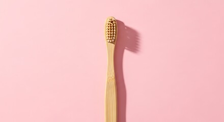 Bamboo Toothbrush on Pink Background