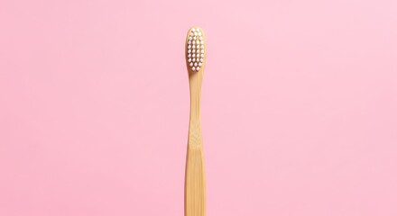 Bamboo Toothbrush on Pink Background