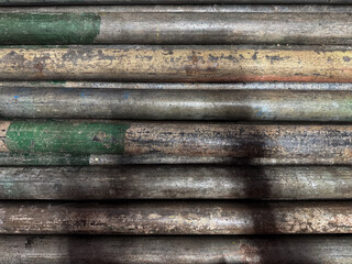 A pile of rusty pipes in an old factory used for industrial purposes and this photo for backdrop