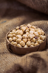 Hazelnuts and Almonds in Paper Containers on White Background – Isolated Nuts