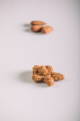 Marinated Nuts with Brown Sauce and Sesame on White Background– Rustic Gourmet Snack