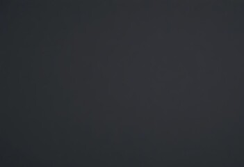 Fototapeta premium A flat, close-up view of a black matte paper's textured surface; a dark gray, abstract background, dark paper, dark gray texture