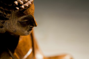 Close-up of wooden Buddha statue on floor