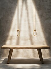 Empty light-wood table, bathed in sunlight, against a textured wall