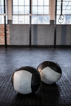 Fototapeta Exercise balls in gym against windows